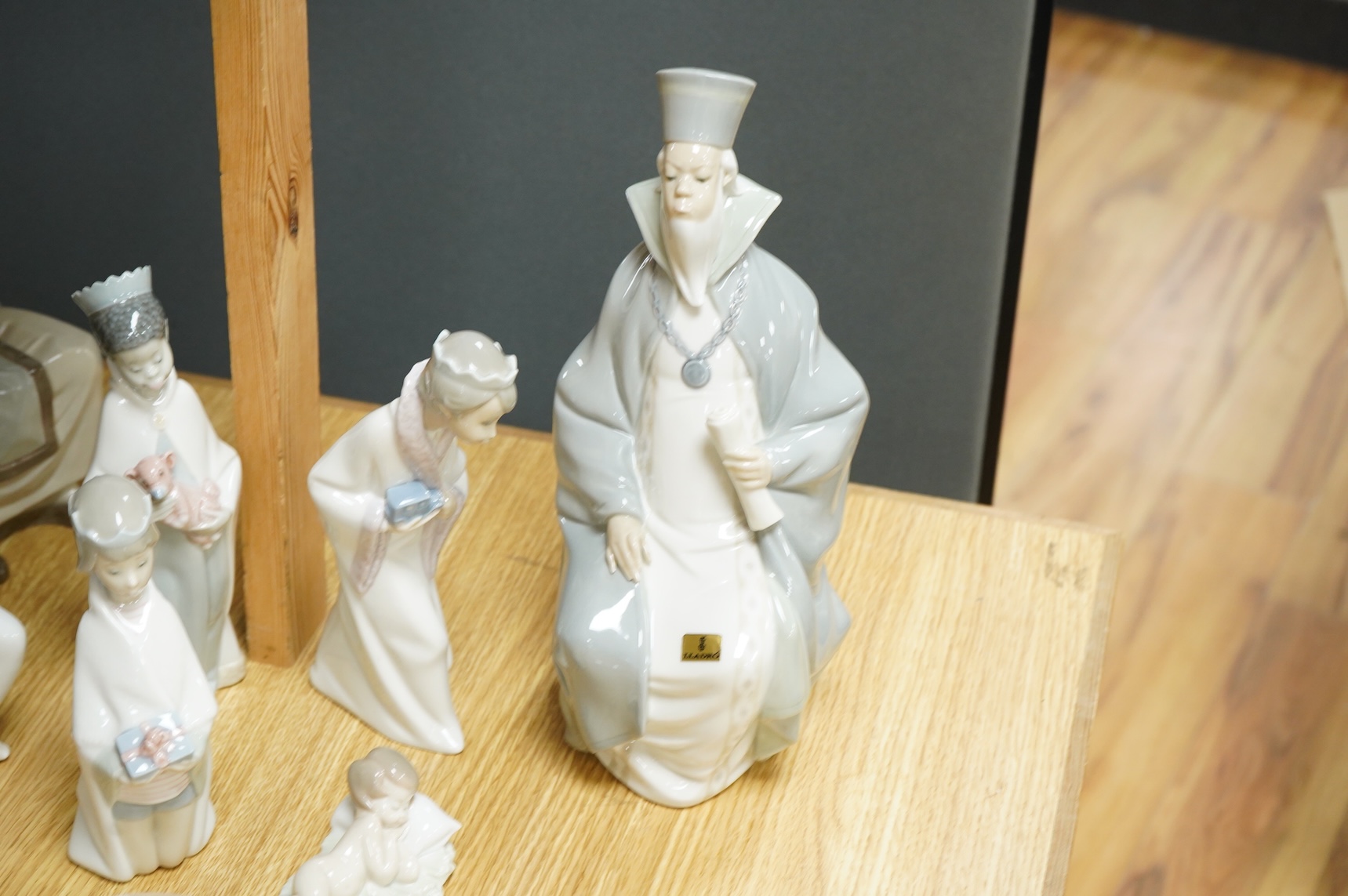A group of Lladro figures Lord & Lady and a Chancellor, 3 Kings, Joseph with Staff and a recumbent child (8)